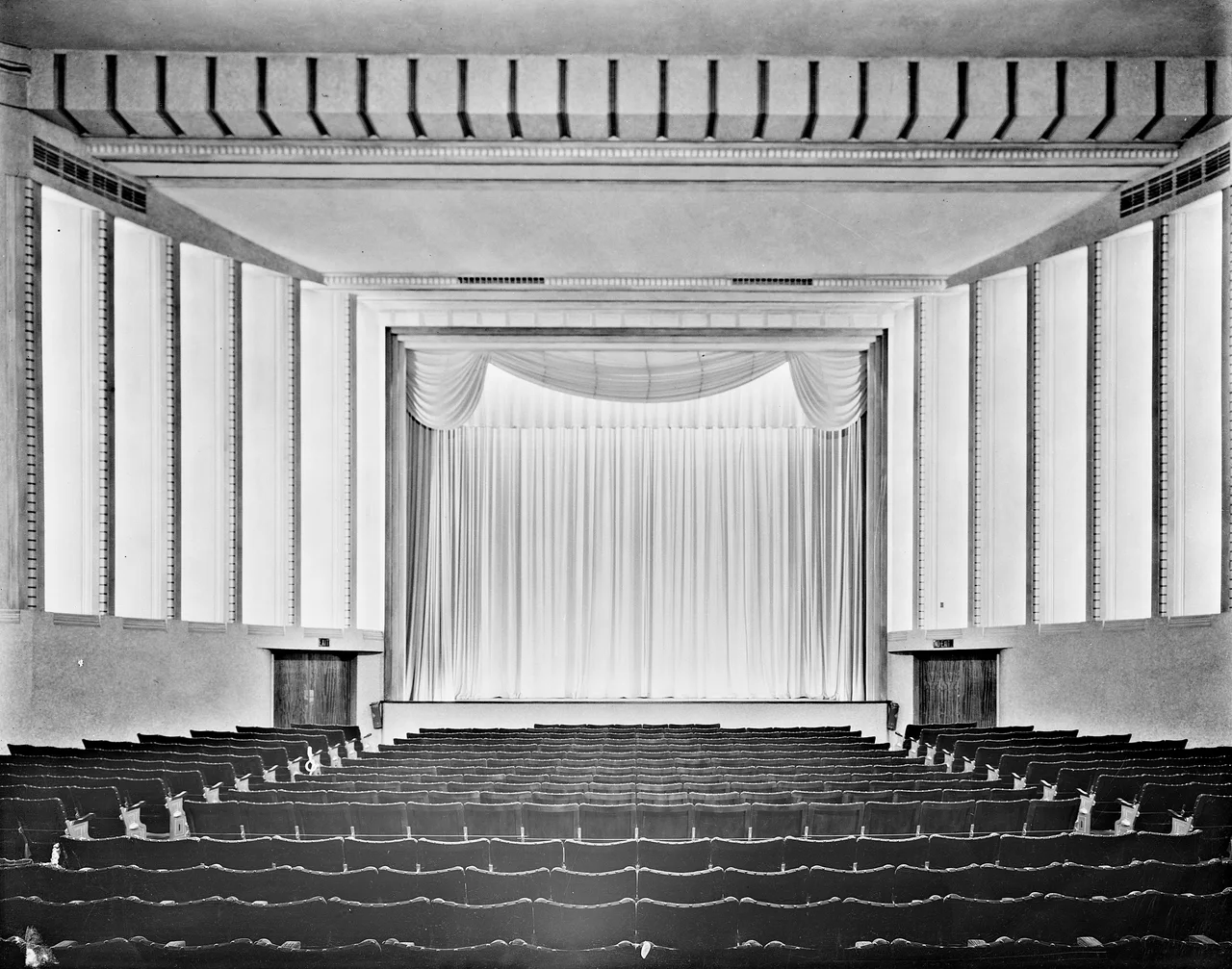 Rows of empty seats facing the curtained stage of the Astor Theatre in Melbourne